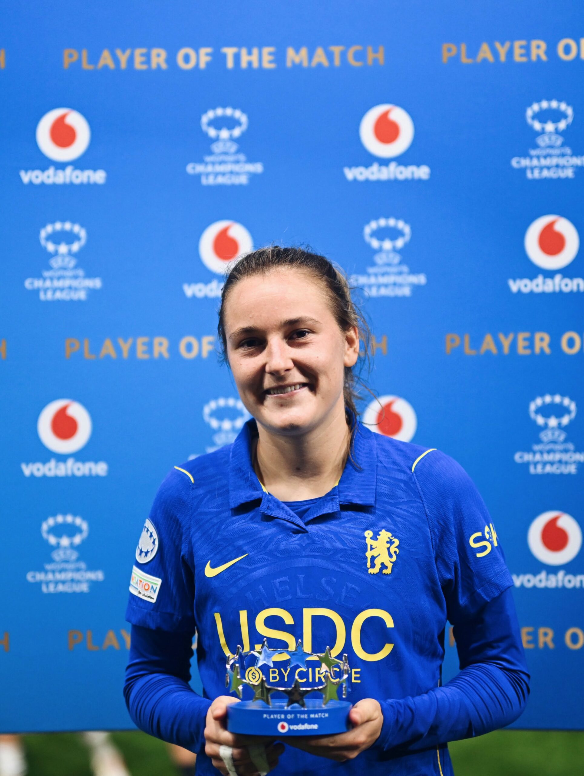 Chelsea Women player holding the Player of the Match award after Roma