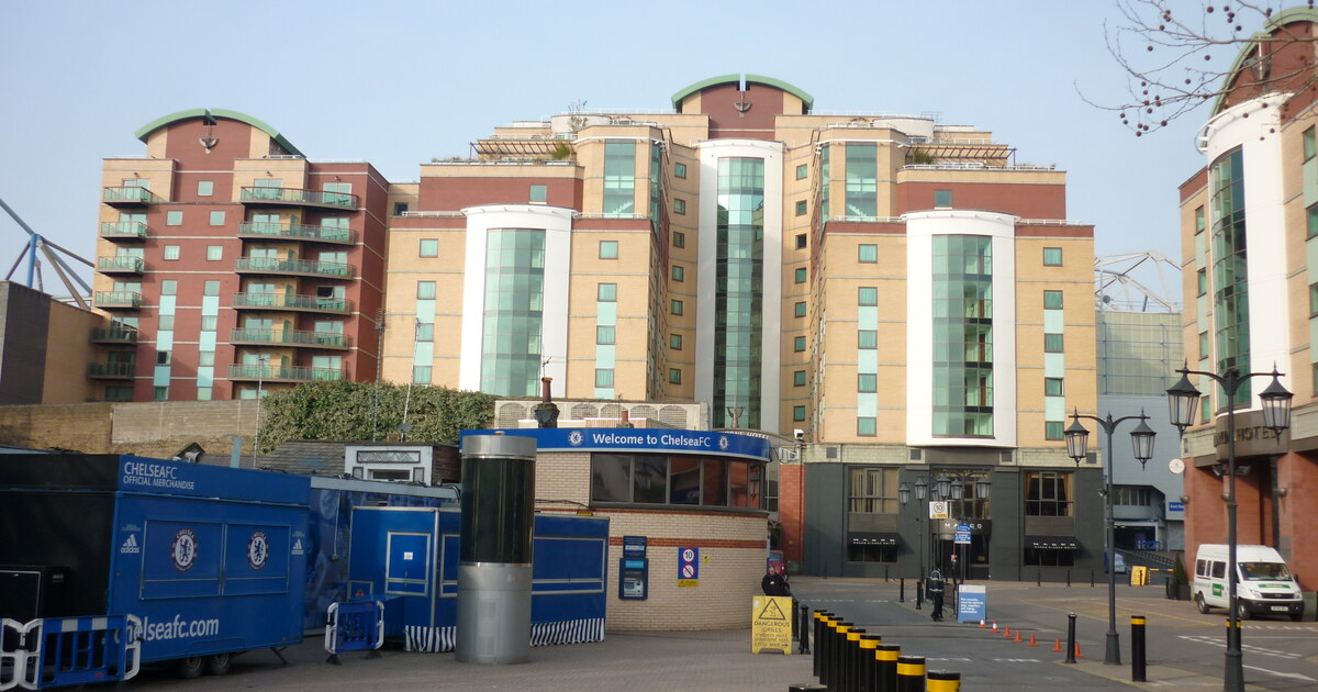 The east entrance area outside Stamford Bridge, Chelsea FC, with the Welcome to ChelseaFC sign and club merchandise unit